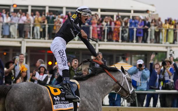 Jaime Torres, atop Seize The Grey, reacts after crossing the finish line to win the Preakness Stakes horse race at Pimlico Race Course, Saturday, May 18, 2024, in Baltimore.