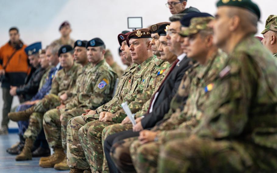 U.S. Army paratroopers from the 82nd Airborne Division, soldiers from the 10th Mountain Division and Romanian military defense counterparts watch the transfer of authority ceremony hosted by the U.S. Army’s V Corps at Mihail Kogalniceanu Air Base, Romania, Dec. 15, 2023.