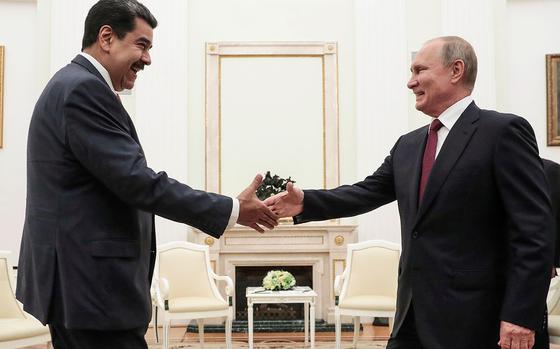 Russian President Vladimir Putin (right) is about to shake hands with Venezuelan President Nicolas Maduro during their meeting at the Kremlin in Moscow on Sept. 25, 2019. (Sergei Chirikov/AFP via Getty Images/TNS)