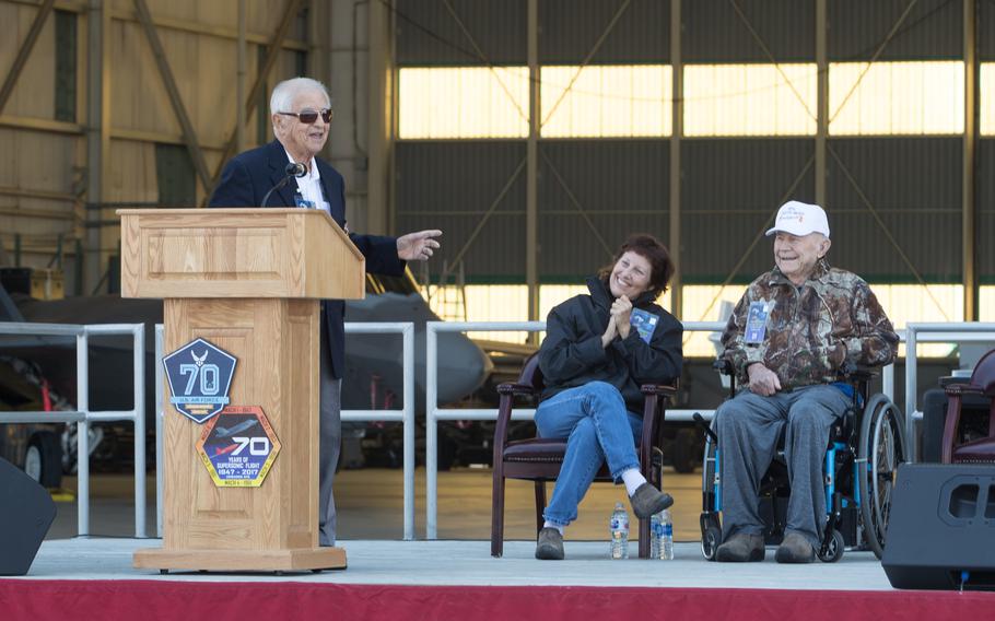 Retired Brig. Gen. Robert Cardenas speaks at the opening ceremony of the 70th Anniversary of Supersonic Flight on October 13, 2017. Behind him is retired Brig. Gen. Chuck Yeager and wife Victoria. Cardenas piloted the B-29 launch aircraft that released the X-1 experimental rocket plane in which Yeager, a captain at the time, became the first man to fly faster than the speed of sound.