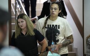WNBA star and two-time Olympic gold medalist Brittney Griner is escorted to a courtroom for a hearing, in Khimki just outside Moscow, Russia, Friday, July 1, 2022. 