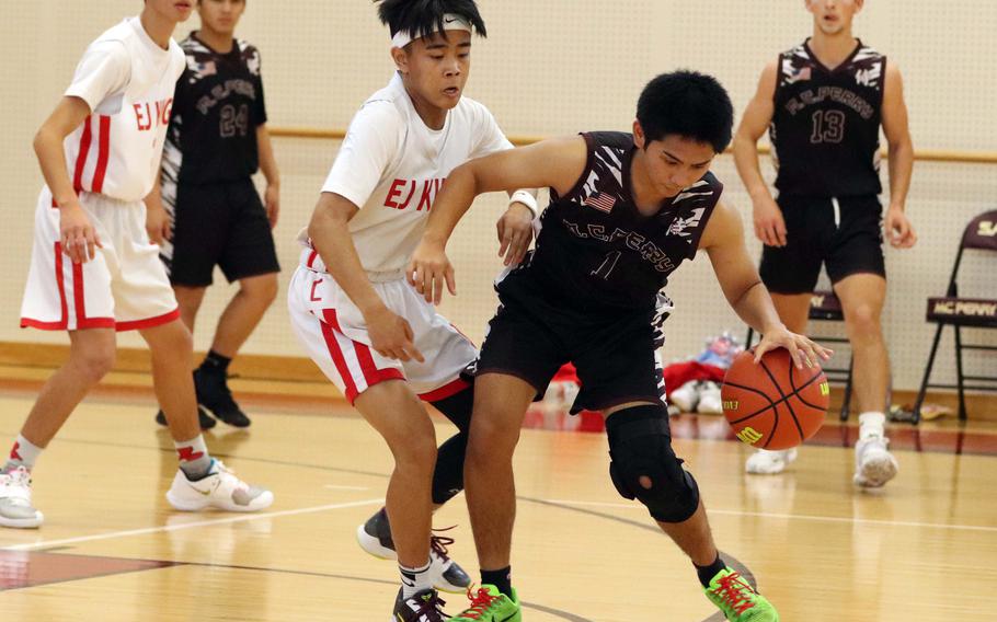 Matthew C. Perry's Joshua Blanquisco keeps the ball away from E.J. King's Arjae Lurente during Saturday's DODEA-Japan basketball game. The Samurai won on a buzzer-beating shot 56-55.