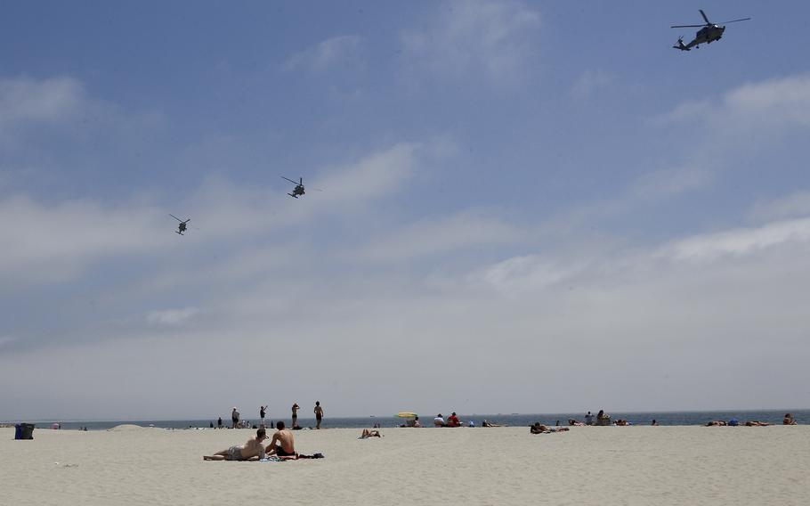 Part of a Navy helicopter squadron flies over beachgoers on the Coronado Beach in Coronado, Calif., May 22, 2012. Coronado Beach has been ranked No. 6 on the list of the nation’s best beach for 2023, according to the annual ranking released May 18 by the university professor known as “Dr. Beach.” 