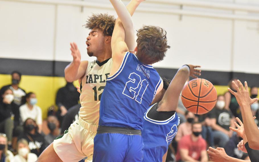 Naples' Keith Rascoe is fouled by Rota's Edward DeMeritt while driving to the basket Saturday, March 5, 2022, in the DODEA-Europe Division II boys title game.