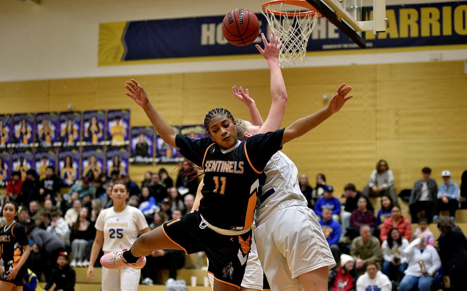 Spangdahlem's Gabrielle Schmidt fights for a rebound with Wiesbaden's Gwen Icanberry during a game on Jan. 19, 2024, at Wiesbaden High School in Wiesbaden, Germany.