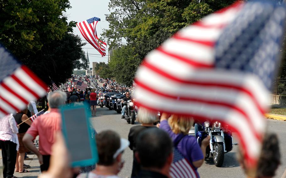 Thousands of people on motorcycles drive past the crowd during the funeral procession for Marine Corps Cpl. Humberto "Bert" Sanchez on East Market Street on Sept. 12, 2021, in Logansport, Ind.