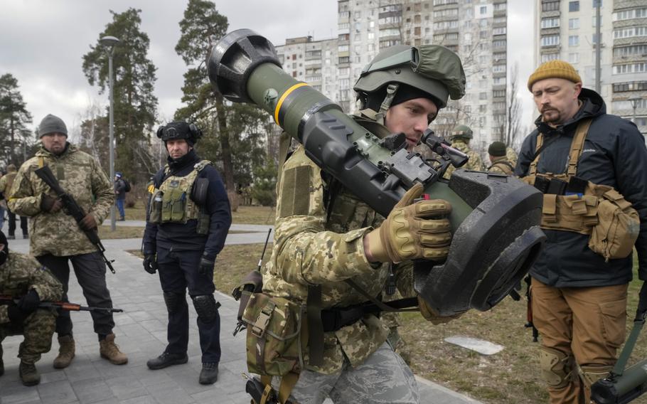 A Ukrainian Territorial Defence Forces member holds an anti-tank weapon in the outskirts of Kyiv, Ukraine, on Wednesday, March 9, 2022. 