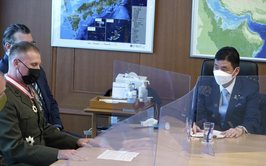 Commander of the U.S. Pacific Marine Corps, Lt. Gen. Steven Rudder, left, meets with Japanese Defense Minister Nobuo Kishi, right, during a courtesy call at the Defense Ministry Friday, June 17, 2022, in Tokyo. (AP Photo/Eugene Hoshiko)