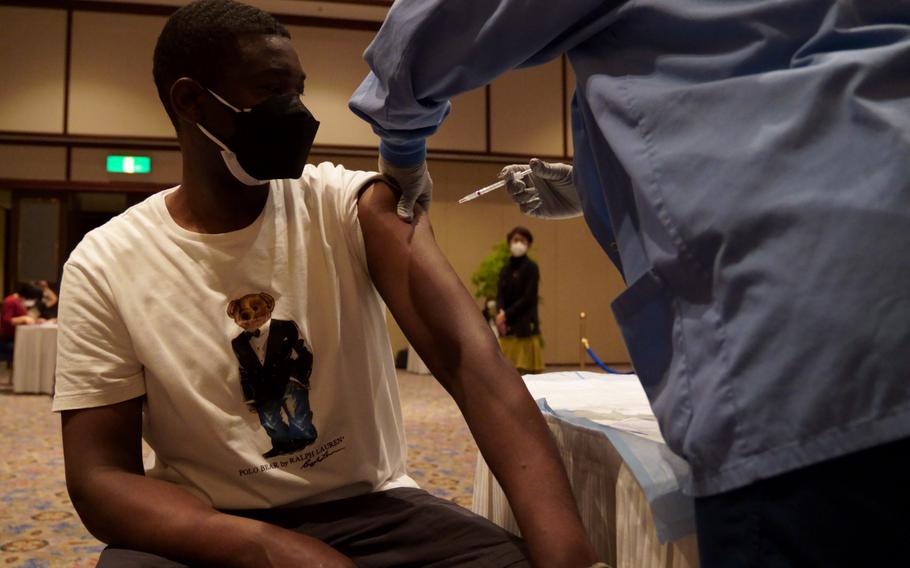 Erastus Nduru, manager of an eatery inside the New Sanno Hotel in Tokyo, gets a COVID-19 vaccine at the Navy-run facility on Feb. 16, 2022.