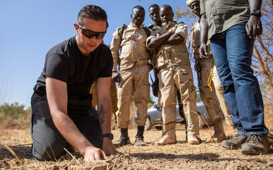 Spc. Zachery Azpeitia, with the 763rd Ordinance Company, gives a class on remote removal of land mines in February 2021 to Burkinabe soldiers at a base on the outskirts of Ouagadougou, the capital of Burkina Faso. U.S. forces will now receive danger pay on deployment to the country, where Islamic militants hold sway and government security forces have been accused of human rights violations.