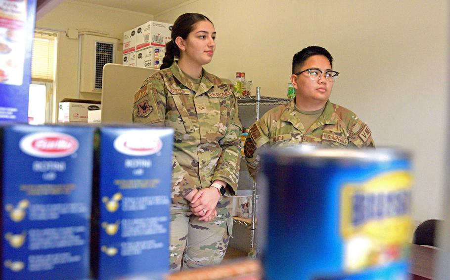 Senior Airman Armanda Jackson, left, and Senior Airman Christina Pruch stand inside their food pantry at Kadena Air Base, Okinawa, March 3, 2023.