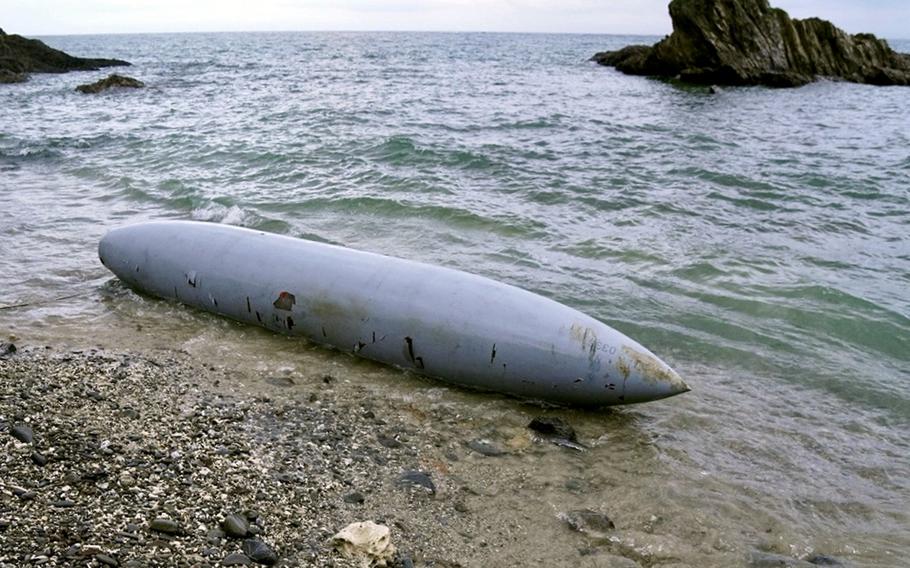 A fuel tank dropped by an F/A-18 Super Hornet assigned to the USS Ronald Reagan washed ashore in Higashi Village, Okinawa, Wednesday, June 1, 2022.