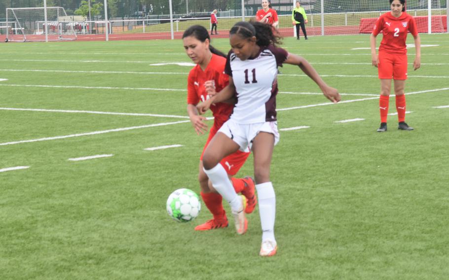 Vilseck's Brennia Waters battles Kaiserslauterns's Yunalesca Luke for the ball during a soccer game at Kaiserslautern on Saturday, April 30, 2022. The Raiders won the game 5-1. 