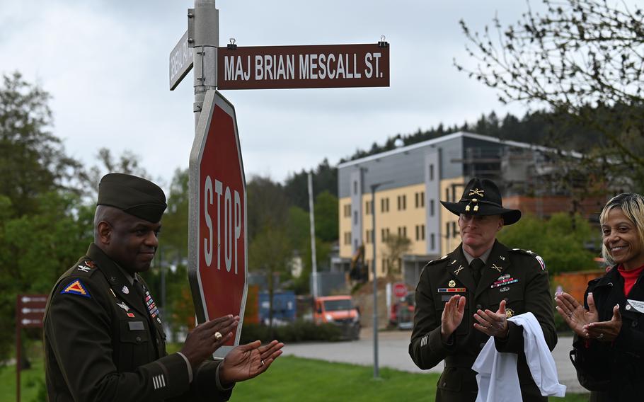 Col. Kevin Poole, left, commander of U.S. Army Garrison Bavaria, and Col. Christopher Danbeck, deputy director of the Army’s Installation Management Command — Europe, celebrate the renaming of a street at Hohenfels Training Area, Germany, in honor of their friend Maj. Brian Mescall during a ceremony at the base.
