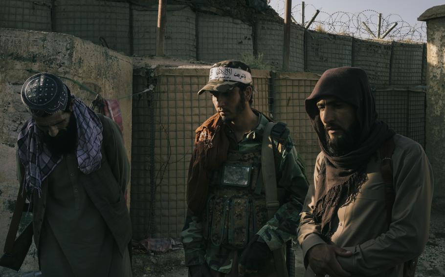 Esmatullah Omari, 19, center, guards a checkpoint Oct. 9 near Bagram air base outside Kabul with men from his unit, including an uncle, left. 