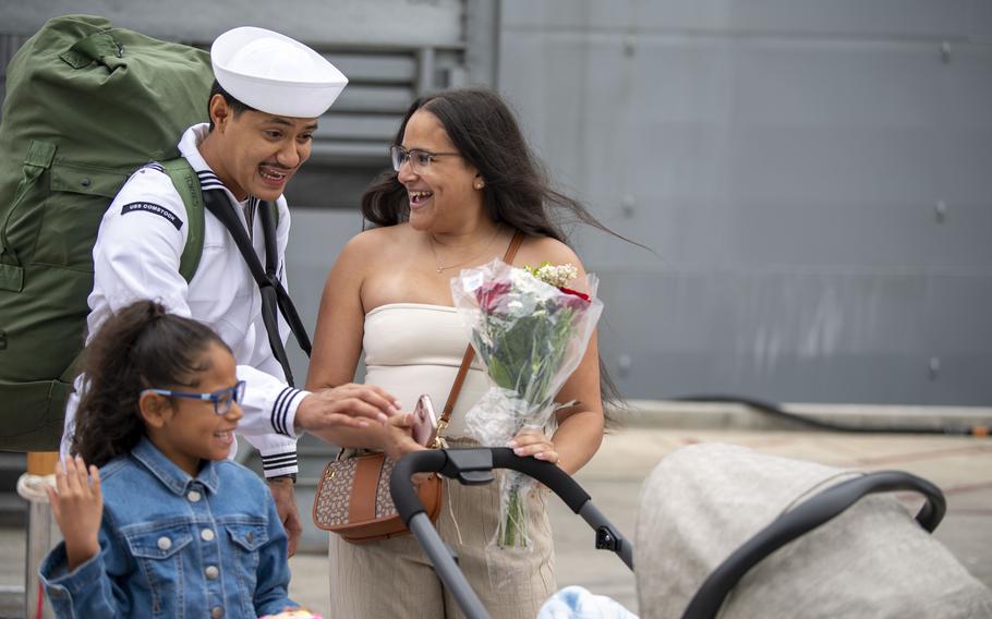 A sailor greets loved ones