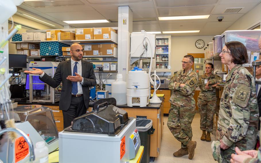 Brigadier General Wendy L. Harter (right) visits the  Emerging Infectious Diseases Branch at the Walter Reed Army Institute of Research to meet with Dr. Kayvon Modjarrad (left) and discuss COVID-19, vaccine research/development and other emerging threats.