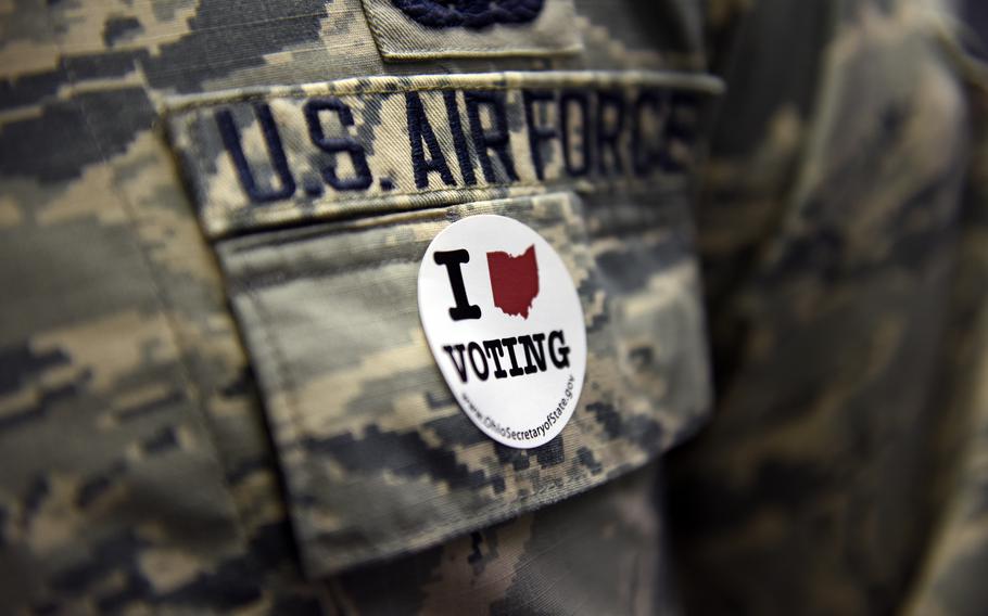 An airman assigned to the 180th Fighter Wing in Swanton, Ohio, wears a voting sticker on election day on Nov. 8, 2016. 