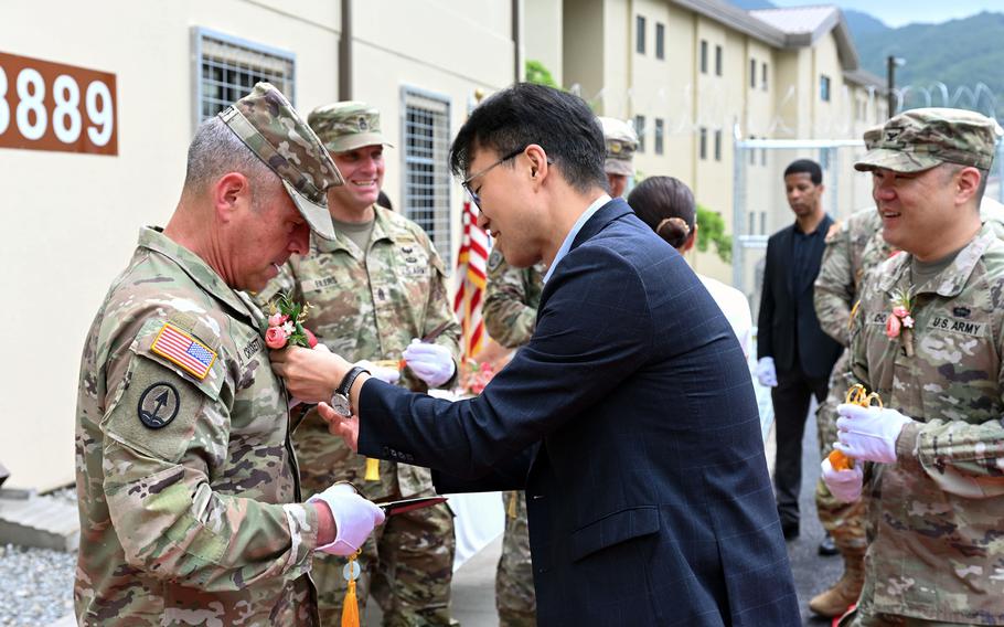 A brigade general receives a floral decoration during a ceremony in South Korea.