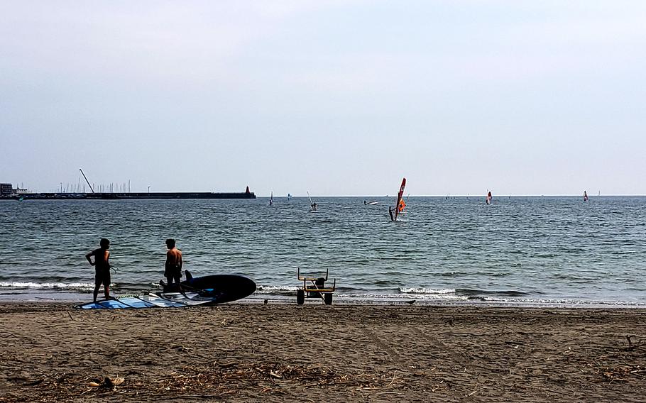 People enjoy Zushi Beach, not far from Yokosuka Naval Base, Japan, on Monday, June 26, 2023.