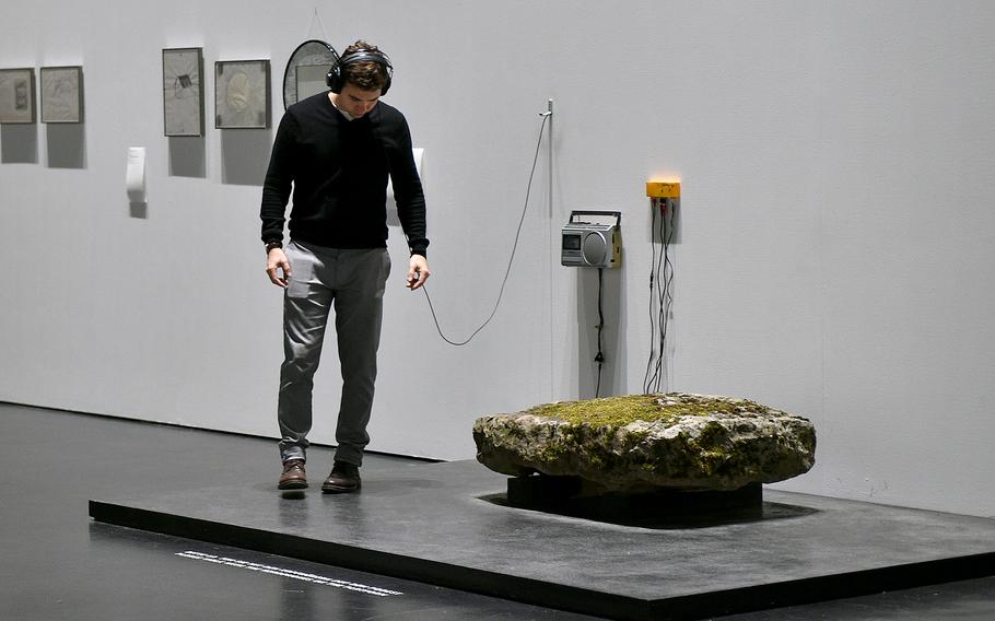A visitor listens to his footsteps as part of work by Korean-French artist Kim Soun-Gui at the Zentrum fuer Kunst und Medien Karlsruhe on Nov. 26, 2022, in Karlsruhe, Germany. The “Kim Soun-Gui: Lazy Clouds” exhibit will be on display until Feb. 5, 2023.