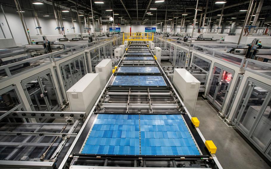 Solar panel cells move along a conveyor prior to lamination and framing at the Hanwha Q Cells manufacturing facility in Dalton, Georgia, on Oct. 6. 