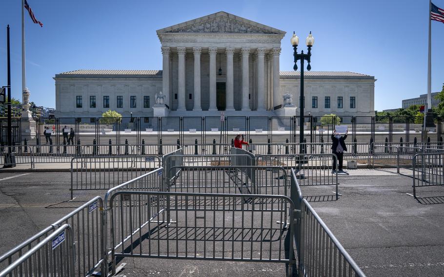 Pens for protesters are set up before anti-scaling fencing that blocks off the stairs to the Supreme Court, Tuesday, May 10, 2022, in Washington. 