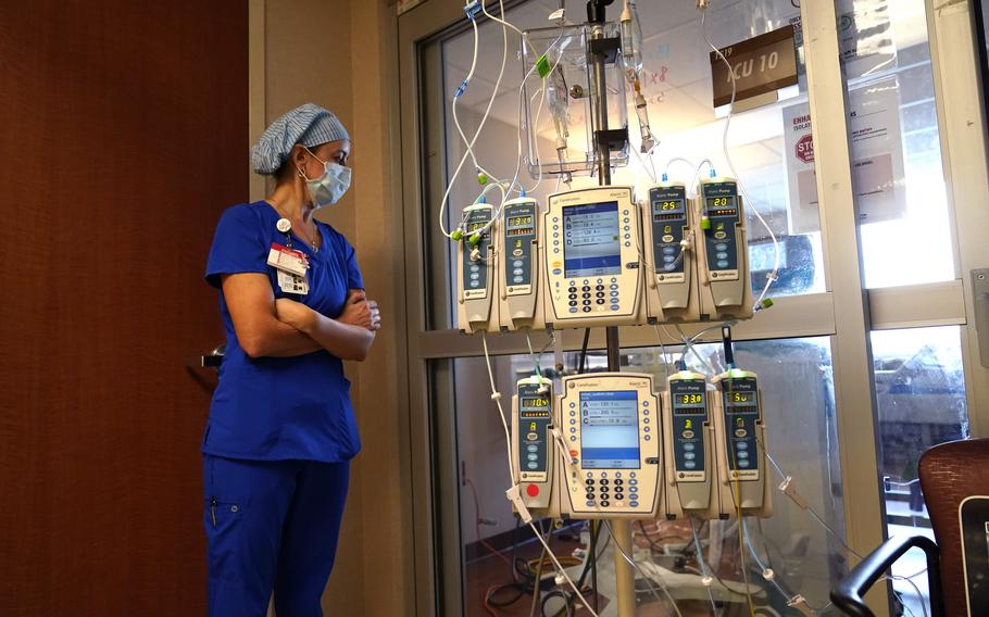 In this Aug. 17, 2021, file photo, nursing coordinator Beth Springer looks into a patient’s room in a COVID-19 ward at the Willis-Knighton Medical Center in Shreveport, La. A decline in COVID-19 cases in the United States over the last several weeks has given overwhelmed hospitals some relief, but administrators are bracing for yet another possible surge as cold weather drives people indoors. 