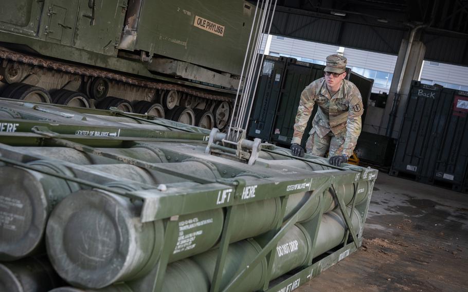 Spc. Bryce Ballard of Alpha Battery, 1st Battalion, 6th Field Artillery Regiment helps move training pods for the Multiple Launch Rocket System in Grafenwoehr, Germany, on Feb. 1, 2024. 