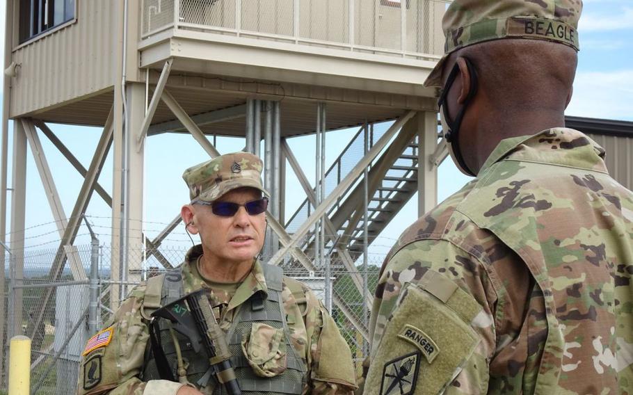 U.S. Army Staff Sgt. Monte Gould, a 59-year-old graduate of Basic Combat Training, speaks with Brig. Gen. Milford H. Beagle Jr., then-Fort Jackson’s commander, during a pause in rifle marksmanship training in 2020. Gould, who had previously completed Marine Corps boot camp, joined the Army later in life, after a break in service.