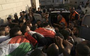 Palestinian mourners carry the body of Fayez Damdoum in the West Bank village of Azariyah, Saturday, Oct. 1, 2022. Israel's paramilitary border police said forces shot a protester who attempted to throw a firebomb at them as they came to disperse a demonstration. It said demonstrators threw stones and explosives at them. The Palestinian Health Ministry identified the dead youth as 18-year-old Fayez Damdoum. (AP Photo/Mahmoud Illean)