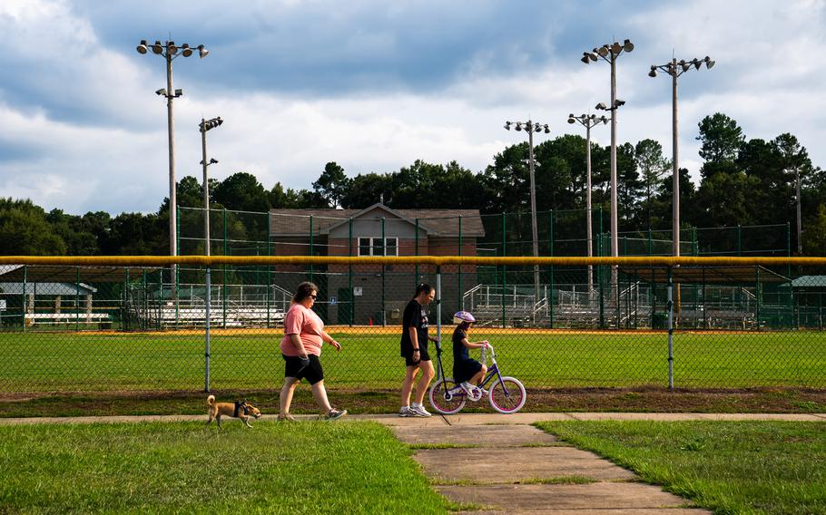 People stroll through Eisenhower Park in Augusta, Ga. 