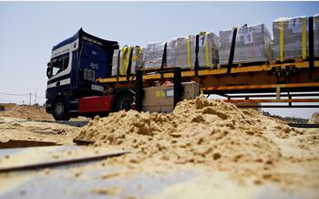 A truck delivers humanitarian aid using the U.S.-built temporary pier off the Gaza coast on May 18, 2024.