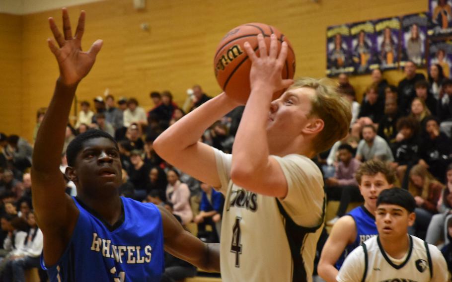 AFNORTH’s Jackson Lojka gets off a shot before Hohenfels’ Jacob Idowu can get to him in a Division III semifinal Friday, Feb. 16, 2024, at the DODEA European Basketball Championships in Wiesbaden, Germany.