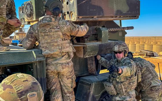 U.S. Army Staff Sgt. David Deering, with the 263rd Air Defense Artillery, Task Force Armadillo, calls for a tool as the team works on the Avenger air defense system's machine gun at al-Tanf Garrison, Syria, Feb. 26, 2025. 