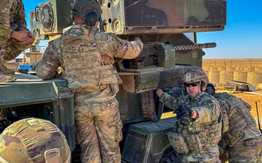 A U.S. soldier works on the Avenger air defense system’s machine gun in Syria.