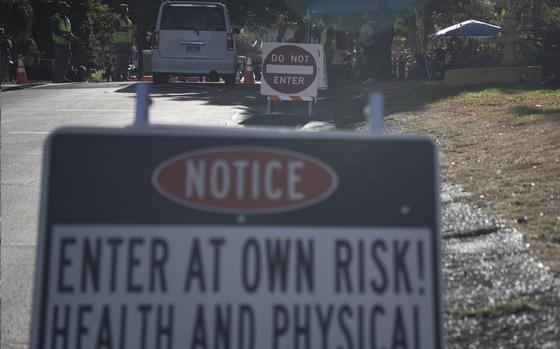 The Hawaii National Guard checks on a car passing the checkpoint on Kaniau Street on Monday, Sept. 25, 2023, in Lahaina, Hawaii. Kaniau Street of Zone 1C is the first zone to be cleared for re-entry starting today. (AP Photo/Mengshin Lin)