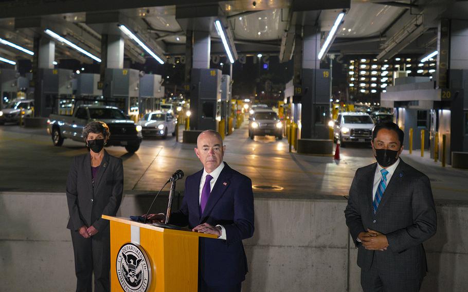 Department of Homeland Security Alejandro Mayorkas, center, attends a briefing at San Ysidro Port of Entry on Dec. 7, 2021, in San Diego. 