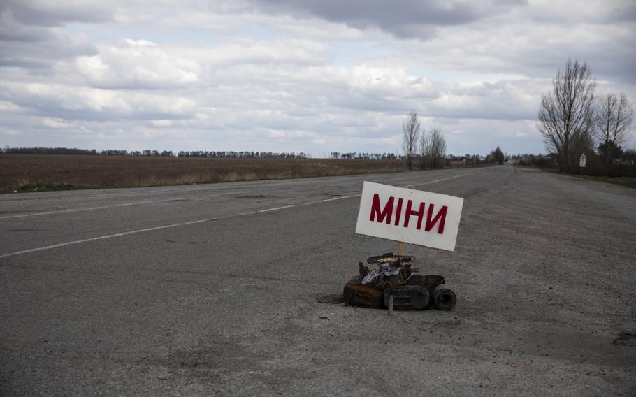 A sign warns of mines on a main road outside of Makariv, Ukraine. 