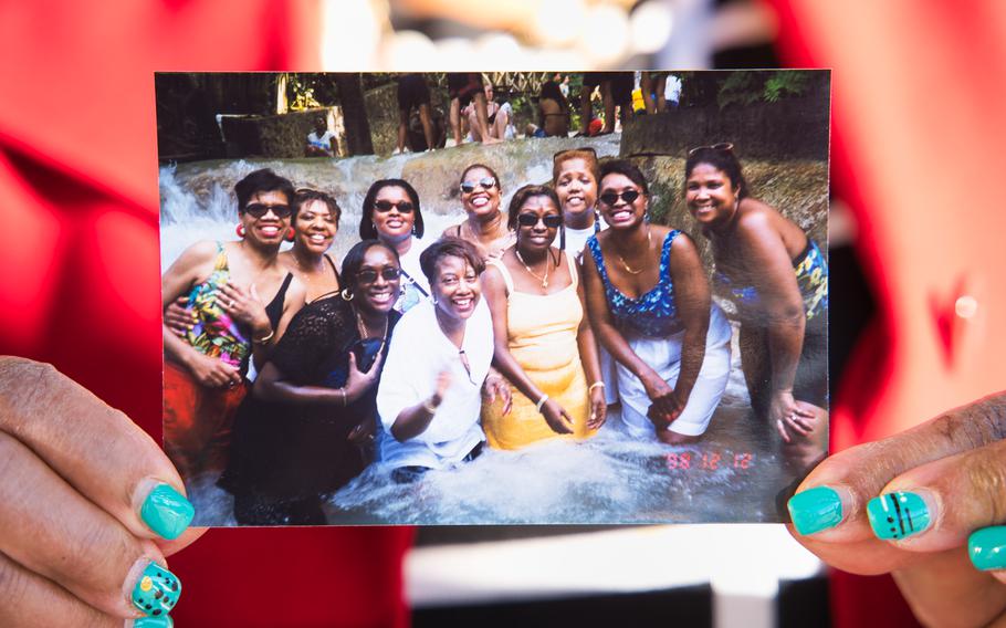 Joyce Wynn Dawkins holds a photo showing some of the Sugar Hill women. The group has been on adventures around the world. 