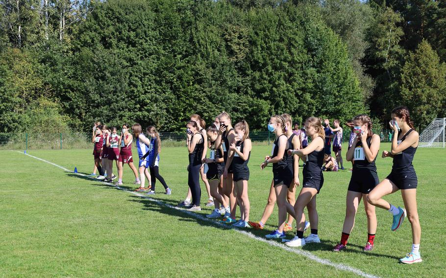 The girls from Stuttgart, Hohenfels, and Vilseck High Schools prepare to start the cross country meet at Vilseck, Germany, on Saturday, Sept. 25, 2021.