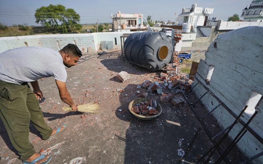 A man sweeps away debris.