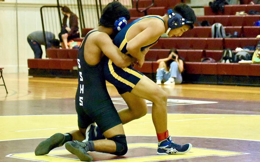 Guam High's Tavion Duenas works an escape against Simon Sanchez's Jayden Borja en route to a win by decision 5-2.