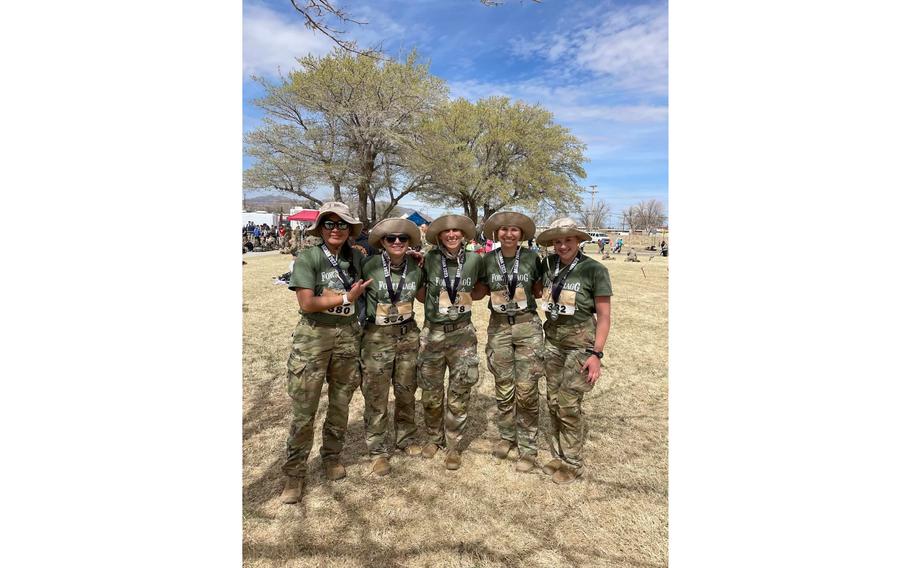 The Fort Bragg Women’s Bataan Memorial Death March Team stands together after claiming victory in the military heavy division of the 34th Bataan Memorial Death March, Sunday, March 19, 2023.