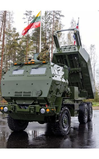 A vertical photo of a HIMARS with the launch system aimed upwards.