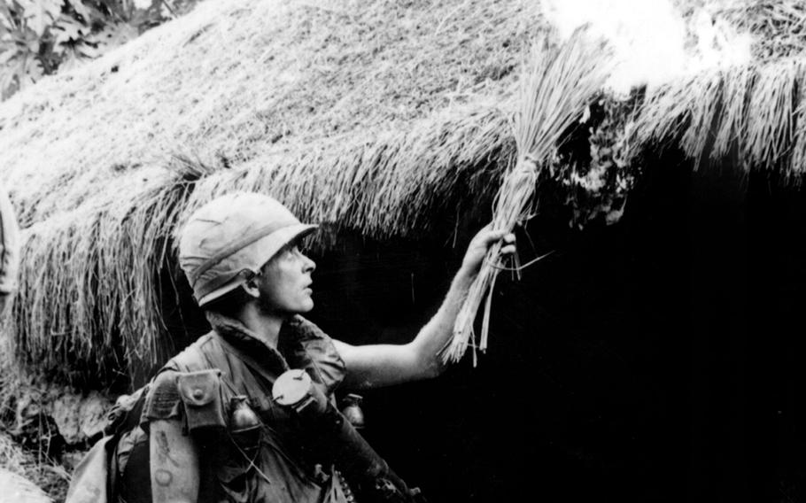 A U.S. soldier sets fire to a Vietnamese home during the My Lai Massacre, March 16, 1968.