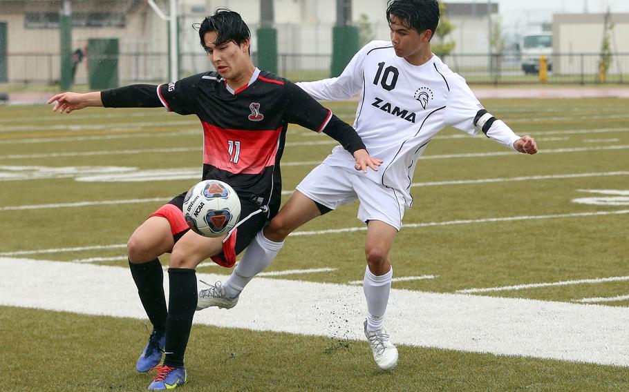 E.J. King's Joseph Barrett steadies the ball against Zama's Gabe Rayos during Tuesday's Division II boys soccer match. The Cobras won 1-0.