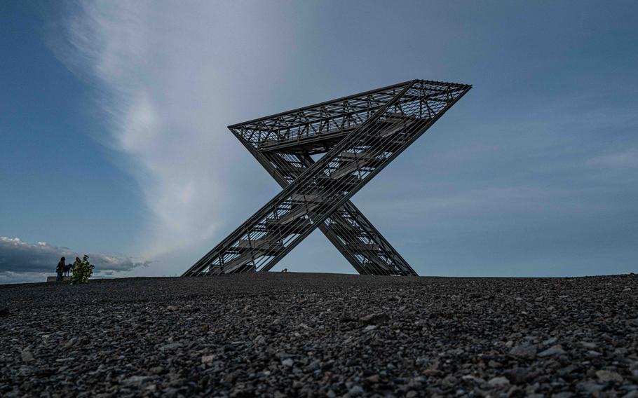 Visitors look at the Saar Polygon atop the Duhamel coal tip in Ensdorf, Germany, on Aug. 27, 2023. The steel structure has a 360-degree viewing platform.