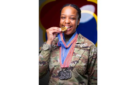 Sgt. Kylie De La Rouche with the gold and silver medals she won at the 48th Joint Culinary Training Exercise in the MacLaughlin Fitness Center on Fort Gregg-Adams, Va., on March 8, 2024.