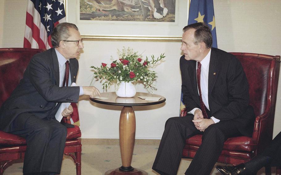 U.S. President George H. Bush, right, talks with the European Commission President Jacques Delors in Bush’s Munich hotel, on July 7, 1992, during the 18th World Economic Summit. 